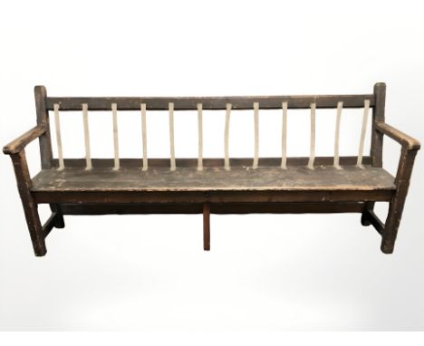 A Victorian stained pine railway bench, 215 cm long.