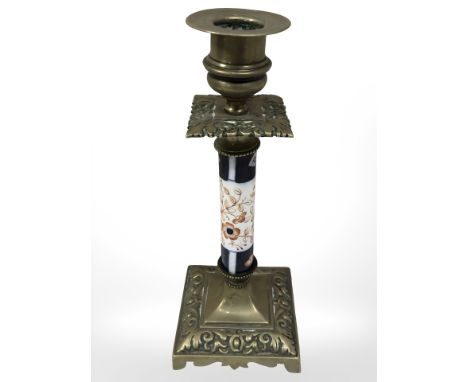 A Victorian brass candlestick with porcelain column, height 22 cm.