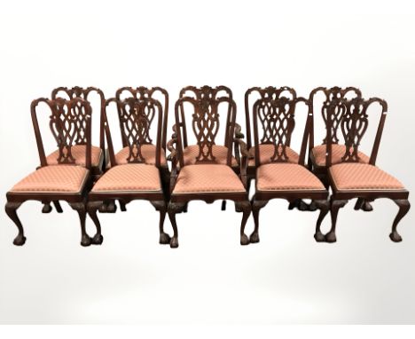 A reproduction set of ten stained and carved hardwood Chippendale style dining chairs comprising eight singles and two carver