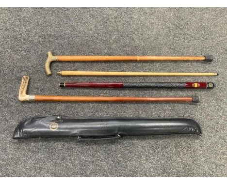 A two piece BCE Custom Cues Ronnie O'Sullivan snooker cue, in carry case, an antler-handled walking stick and a brass-handled