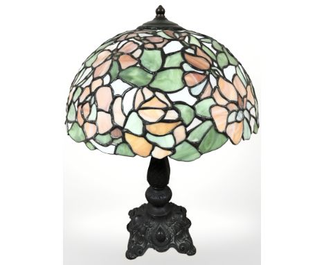 A patinated metal table lamp with Tiffany style leaded glass mushroom shade, height 52 cm.