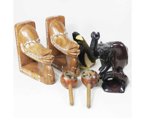 A pair of Solomon Islands carved wooden canoe heads, with mother of pearl inlay, 24cm high, together with a pair of South Ame