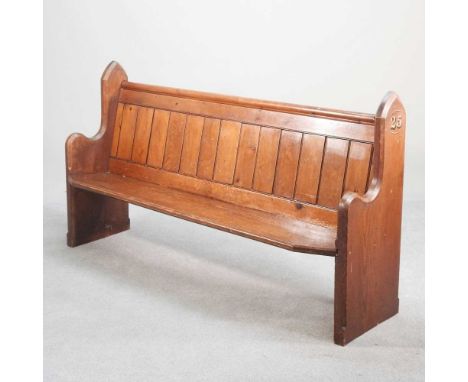 A 19th century Gothic style stained pine pew, with a boarded back,164w x 48d x 91h cm