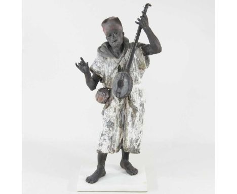 Style of Franz Bergmann, late 19th century, a large painted spelter figure of a Bedouin man, holding a lute, on an alabaster 