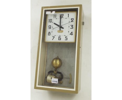 Brillie electric wall clock, the 6" square white dial within a glazed light brown metal case with marble back, 17" high