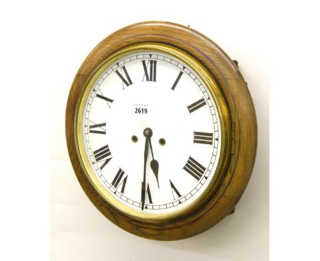 Oak two train 12" wall dial clock, within a turned surround (pendulum)