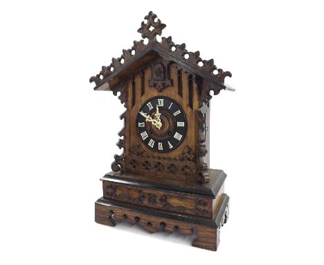 Oak Black Forest two train mantel clock striking on a gong, the 5.25" ebonised dial within a carved stepped gabled case, 21" 