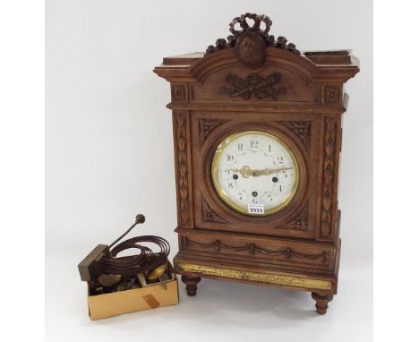 Carved wooden three train bracket clock in need of restoration, the dismantled movement striking on a gong, the 6" enamelled 