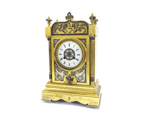 Ormolu two train mantel clock striking on a gong, the 4" plastic covered dial within a cast bezel within an ornate pillared s