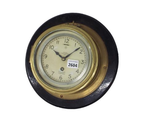 Brass single train ship's bulkhead wall clock, the 5" dial signed Mercer, St Albans, England within a drumhead surround upon 