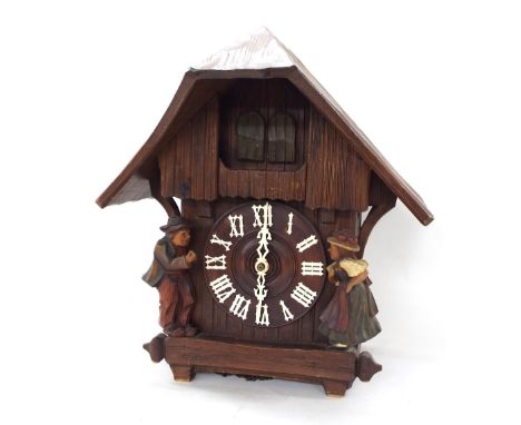 Black Forest triple weight musical cuckoo clock, the case back signed DRGM, 0Z65, the 6" turned wooden dial within a gabled c