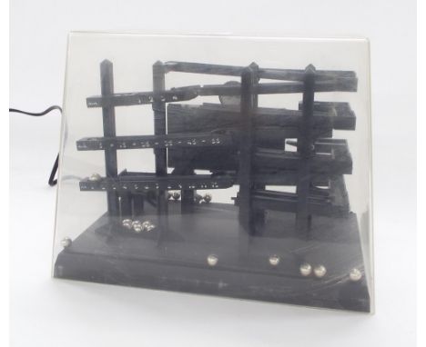 German ball bearing electric clock, 'Elektrische Kugel Uhr', under a Perspex dome, 10" long, with instruction manual