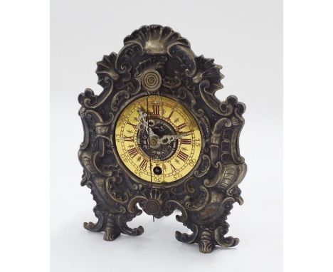 Interesting German mantel clock timepiece, with cowtail pendulum to the front, the 3.75" brass chapter ring within an ornate 