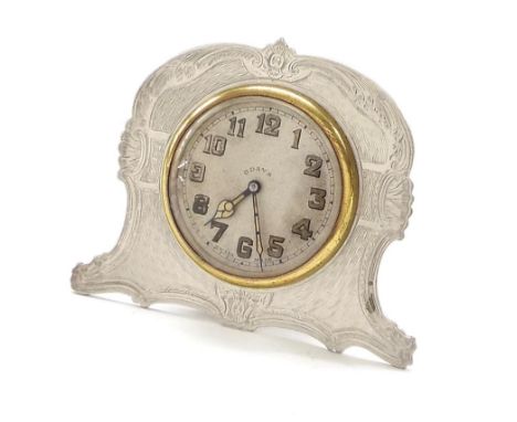 Small silver eight day easel timepiece, the 1.75" cream dial within a shaped engine turned case, 3" high