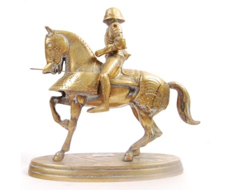 A vintage 1970's brass model sculpture of a Knight on horseback. The knight being in full armour with a jousting lance sat up