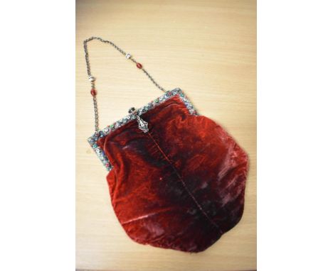 An early 20th century ombre red velvet evening bag, having white metal mount, with enamel and rhinestone detailing and chain 