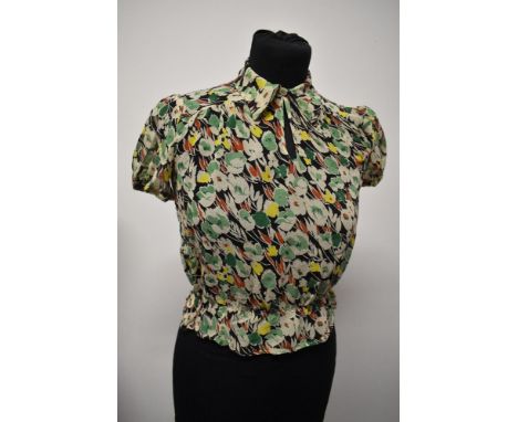 An Art Deco sheer floral crepe blouse, having shirred waist, pointed collar and button fastening.
bust approx 32" and waist u