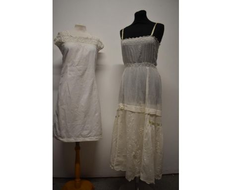 An Edwardian lawn cotton slip, having hand embroidery, scalloped hem, ladder work and ribbon woven through rear of skirt to m