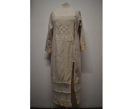 An interesting early 20th century linen smock/ over dress, having embroidered tulle panel to front, deep tiered tulle lace he