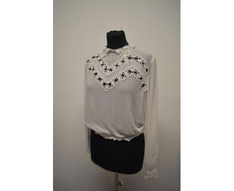 A white crepe georgette and lace 'Eros model' blouse, having long sleeves and button back fastening.