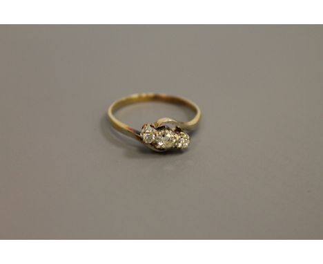 An 18ct gold three stone diamond ring, size Q