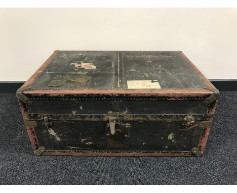 An early 20th century travelling trunk with metal mounts 