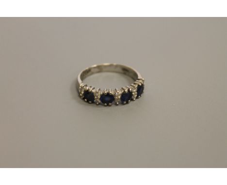 An 18ct white gold sapphire and diamond ring, size N