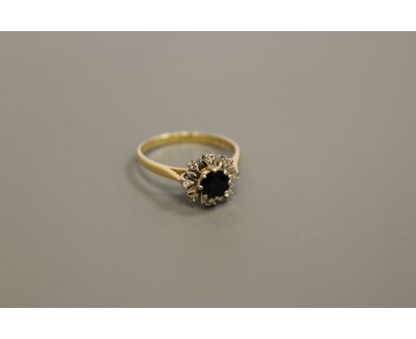 An 18ct gold diamond and sapphire cluster ring