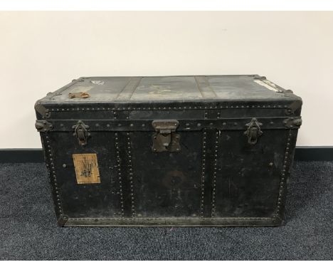 An early 20th century travelling trunk with metal mounts 