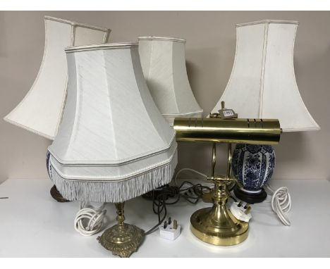 Three blue and white table lamps with shade, a brass lamp with shade and a brass banker's lamp 