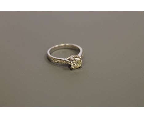 An 18ct gold solitaire diamond ring, the principal brilliant-cut stone weighing approximately 0.9 carat, with diamond set sho