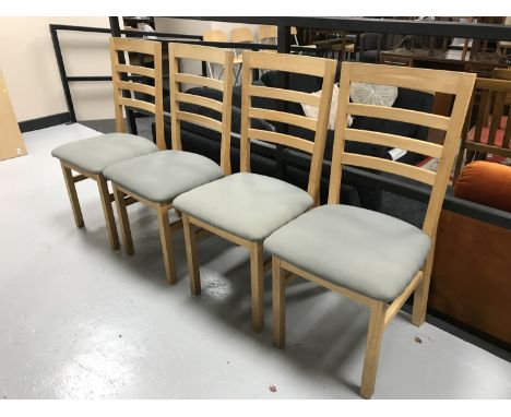 A set of four oak ladder back chairs 