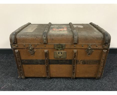 An early 20th century wooden bound travelling trunk 