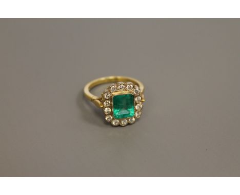 An 18ct gold emerald and diamond cluster ring, size N/O (NB - half of the stones are moissanite replacements)