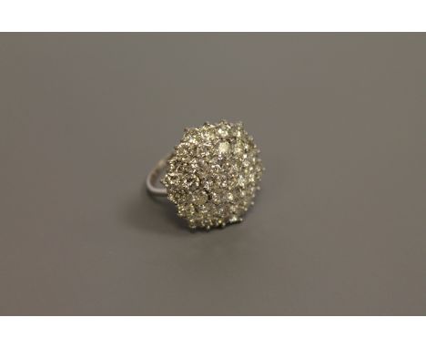 An impressive diamond cluster ring, set with 37 brilliant cut stones, the total diamond weight estimated at 6.0 carats, size 