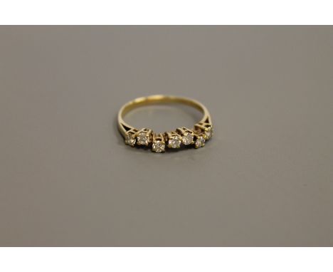 An 18ct gold seven stone diamond ring