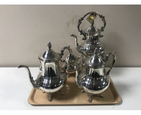 A four-piece 20th century plated tea service and matching spirit kettle 