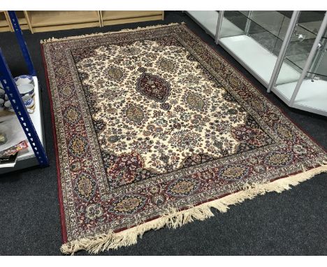 A red fringed woollen carpet on red ground 