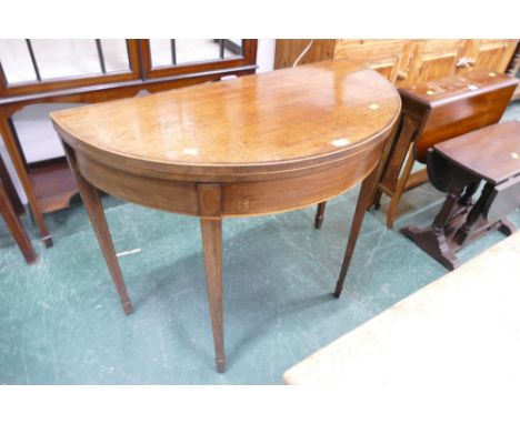 Georgian mahogany and boxwood strung demi lune turn over top card table opening to a blue baize fitted interior 