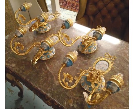 WALL LIGHTS, a set of four, gilt metal and Sevres style ceramic decorated putti each approx 34cm x 42cm H. (4)