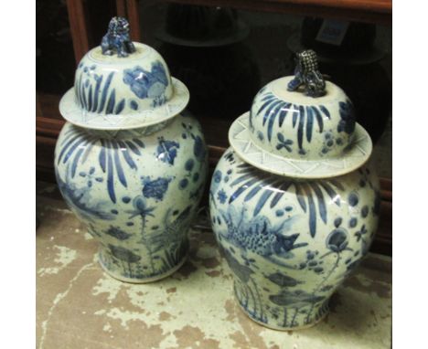 TEMPLE URNS, a pair, Chinese blue and white ceramic, the lids with Foo Dog finials, 62cm H. (2)