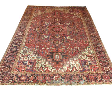 FINE ANTIQUE HERIZ CARPET, 400cm x 295cm, pendant medallion on a terracotta field of stylised organic motifs within correspon