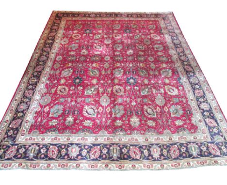 FINE TABRIZ CARPET, 382cm x 300cm, all over design of palmettes and scrolling vines on a ruby field within ivory guard stripe