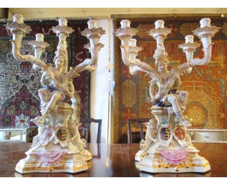 CANDELABRA, a pair, Meissen style ceramic each with figurative supports and four lighting arms, 56cm H. (2)