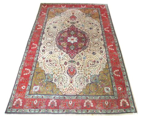 VERY FINE TABRIZ CARPET, 320cm x 204cm, ruby pendant medallion on an ivory field of scrolling vines and leaves within old gol