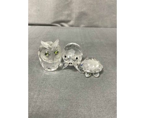 LOT OF SWAROVSKI CRYSTAL ANIMAL FIGURES including hedgehog, swan, owls, pig etc., also a petal shaped candlestick and four un