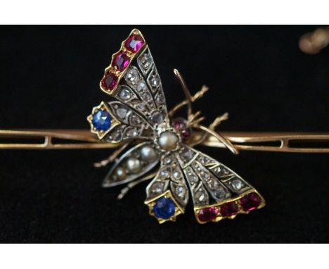 Victorian/Edwardian butterfly brooch set with old cut diamonds, ruby, sapphire &amp; seed pearl. Set in a yellow metal bar. L