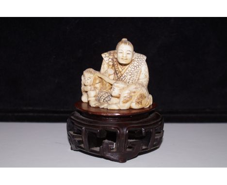 19th Century Netsuke group with inserted red lozenge to base. 