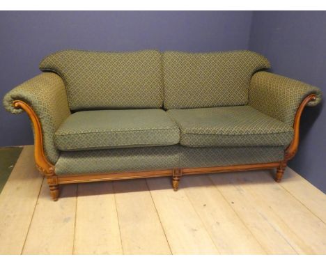 Modern double scroll end settee, with loose seat and back cushions, with a light wood show framed front, upholstered in Green