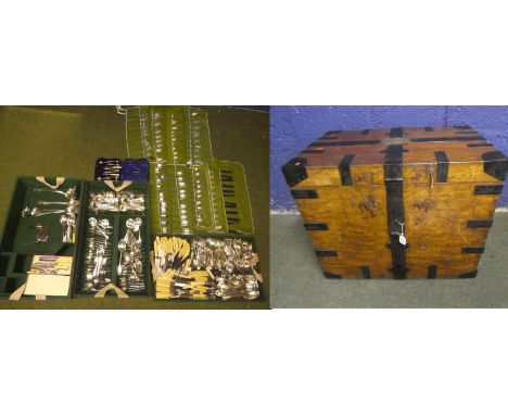 A large oak, iron bound trunk/silver chest, containing a large quantity of plated flatware cutlery etc including a 12 piece s